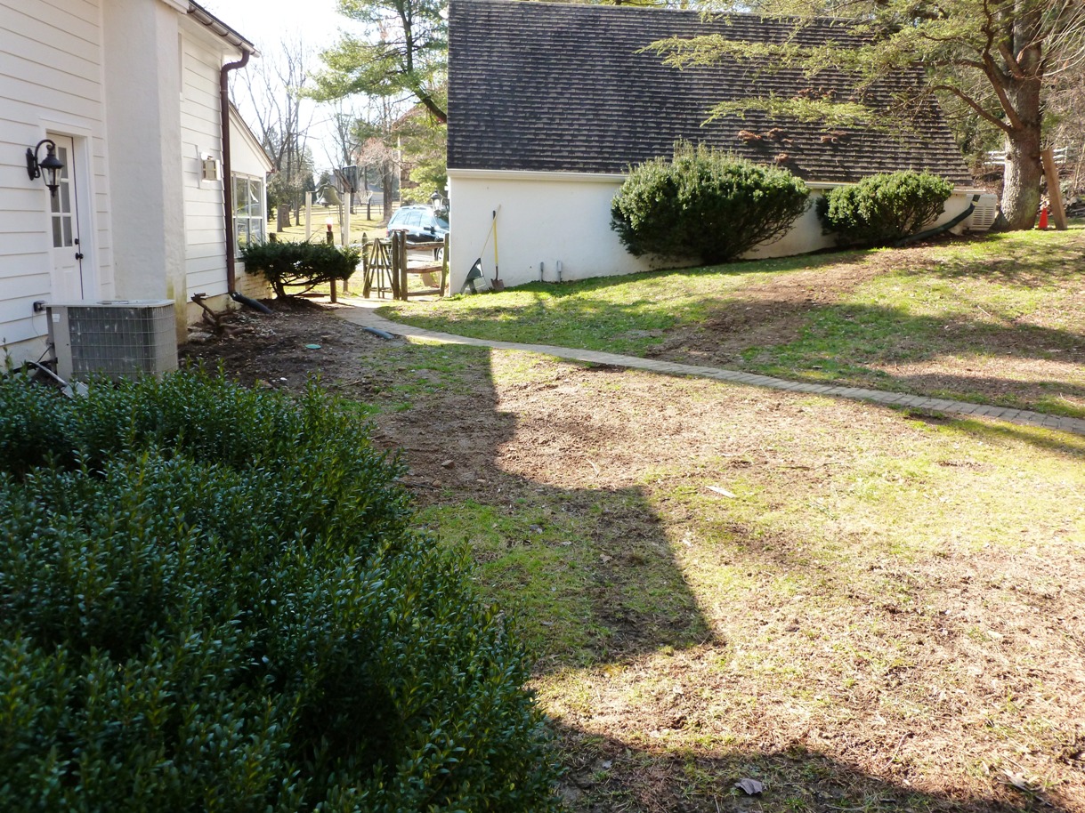 landscape-design-main-line-paver-patio-courtyard-with-stone-wall-before